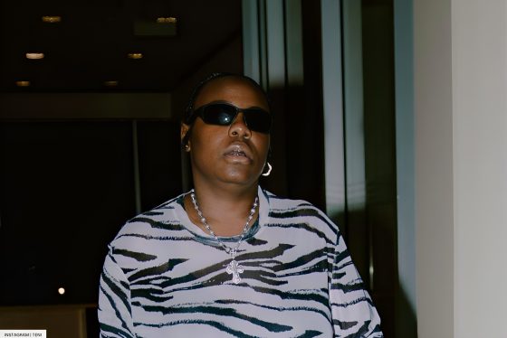 Teni Rocks Cow Print Boots As She Hits Abuja